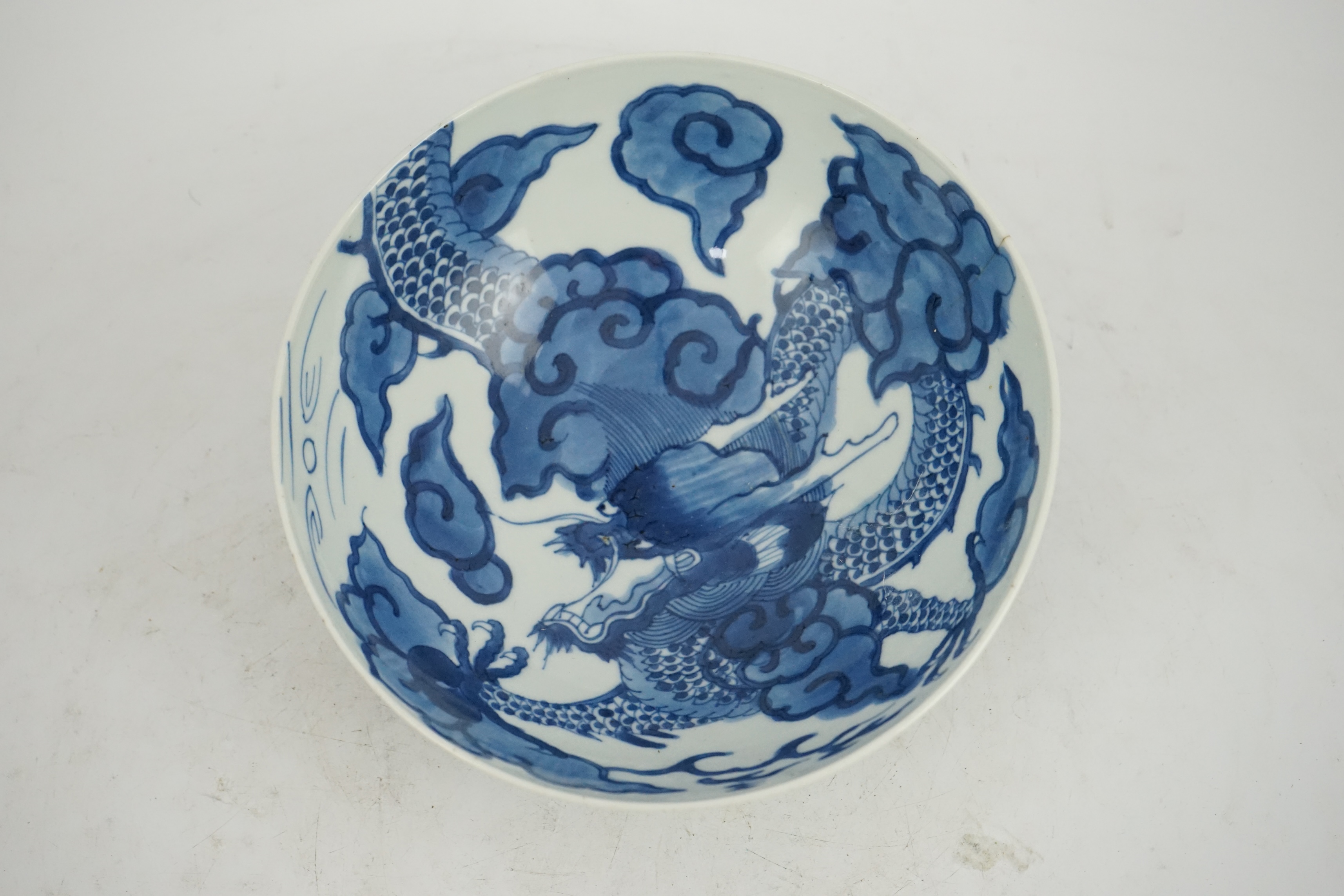 A Chinese blue and white ‘cloud and dragon’ bowl, Yongzheng mark and period (1723-35)